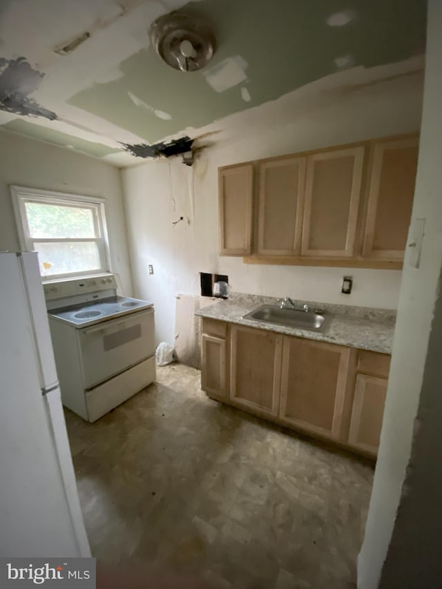 2137 W Toronto St, Philadelphia, PA 19132 - kitchen featuring white appliances, a sink, light brown cabinetry, and light countertops