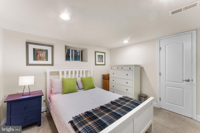 carpeted bedroom featuring baseboards and recessed lighting