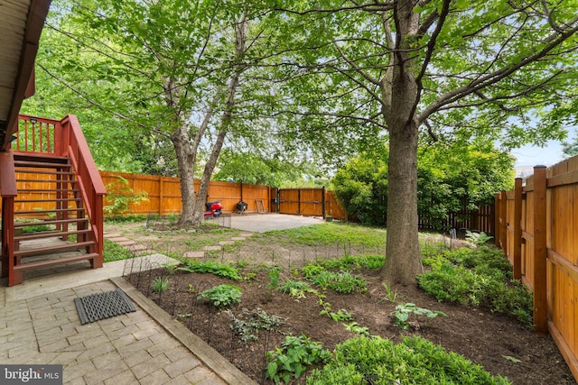 fenced backyard featuring a patio and stairway