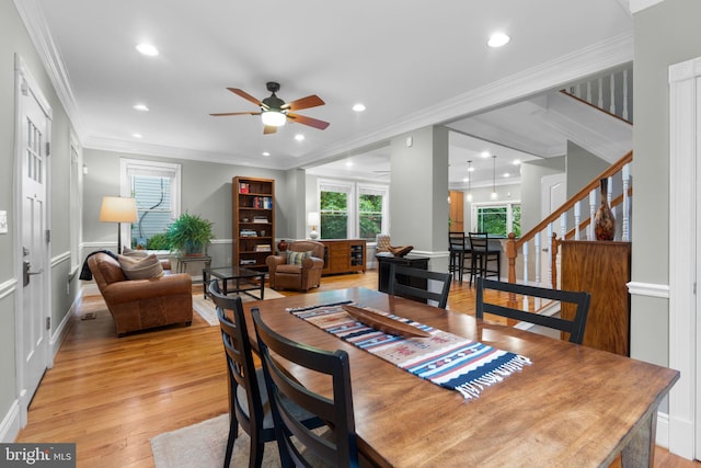 dining space with ceiling fan, stairway, light wood-type flooring, recessed lighting, and crown molding