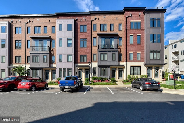view of building exterior with uncovered parking