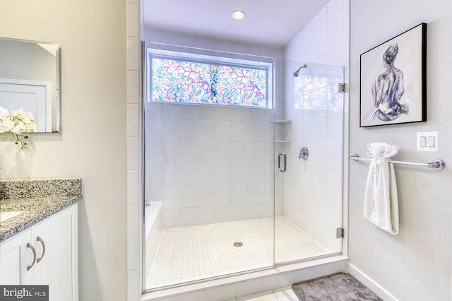 full bathroom with a stall shower, vanity, baseboards, and recessed lighting
