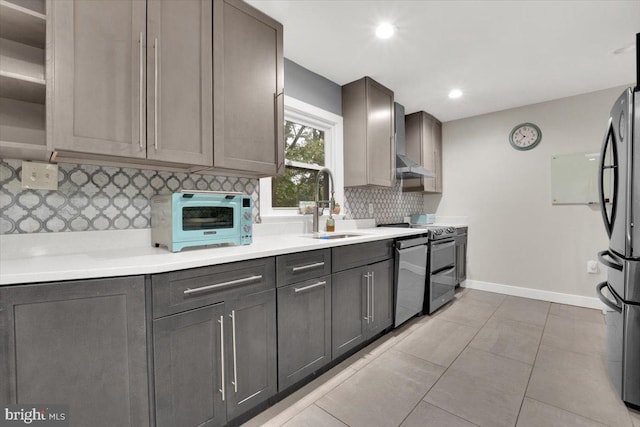 907 Sterling Ct, Herndon, VA 20170 - kitchen featuring a sink, tasteful backsplash, appliances with stainless steel finishes, baseboards, and light countertops