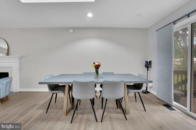 907 Sterling Ct, Herndon, VA 20170 - dining area with light wood-style floors, baseboards, recessed lighting, and a fireplace