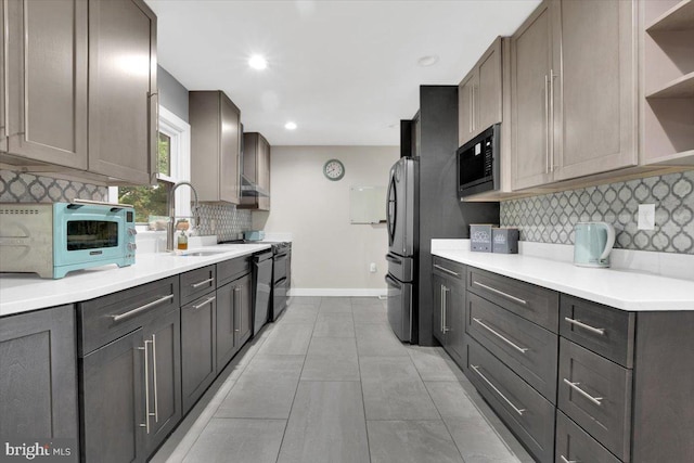 907 Sterling Ct, Herndon, VA 20170 - kitchen featuring open shelves, black appliances, baseboards, a sink, and backsplash