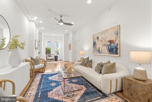 living room with wood finished floors, a ceiling fan, and recessed lighting