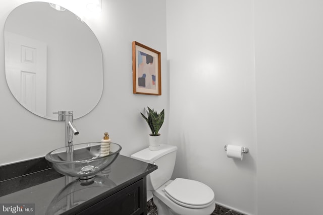 bathroom with toilet and vanity