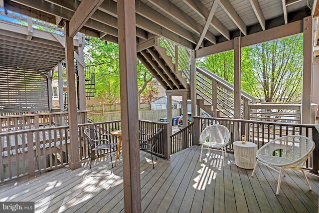 wooden deck featuring stairway and fence