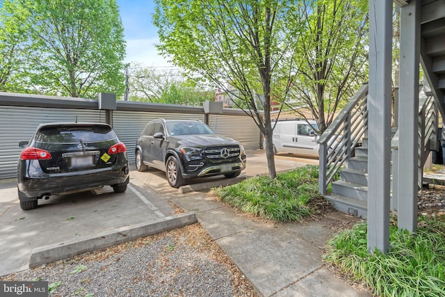 view of parking / parking lot featuring stairway