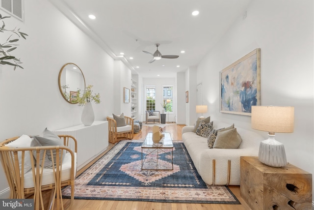 living room featuring wood finished floors, recessed lighting, and a ceiling fan