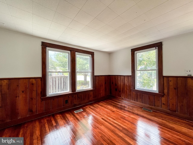 1021 Park Ave, Annapolis, MD 21403 - spare room featuring a wainscoted wall, wooden walls, and wood finished floors