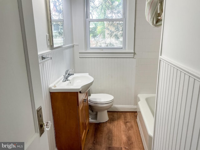 1021 Park Ave, Annapolis, MD 21403 - full bathroom with wainscoting, vanity, a bathtub, wood finished floors, and plenty of natural light