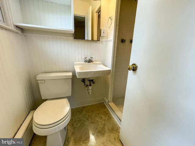 1021 Park Ave, Annapolis, MD 21403 - bathroom featuring marble look tiles, tiled shower, and a baseboard heating unit