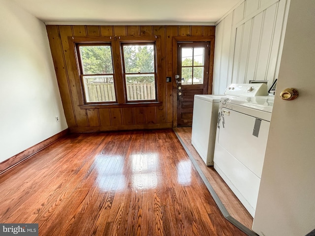 1021 Park Ave, Annapolis, MD 21403 - laundry area featuring washing machine and clothes dryer, wood finished floors, and wood walls