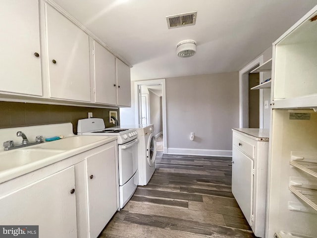 1021 Park Ave, Annapolis, MD 21403 - kitchen featuring washer and dryer, white electric range, dark wood-style flooring, white cabinetry, and light countertops