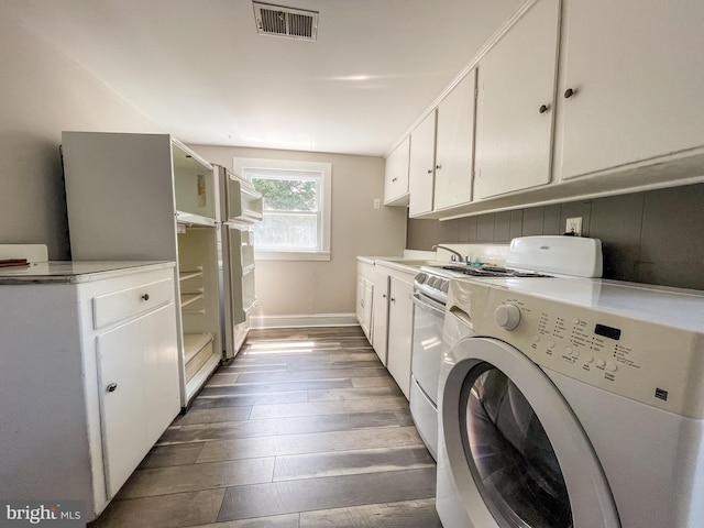 1021 Park Ave, Annapolis, MD 21403 - laundry room featuring cabinet space, independent washer and dryer, and dark wood-type flooring