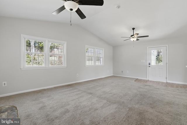 unfurnished living room featuring ceiling fan, plenty of natural light, lofted ceiling, and baseboards