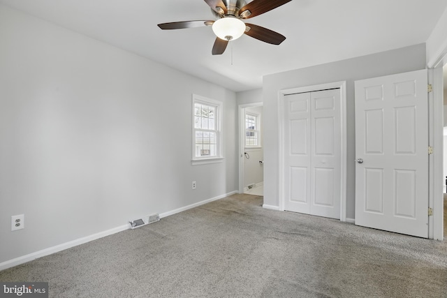 unfurnished bedroom featuring carpet, a closet, baseboards, and a ceiling fan