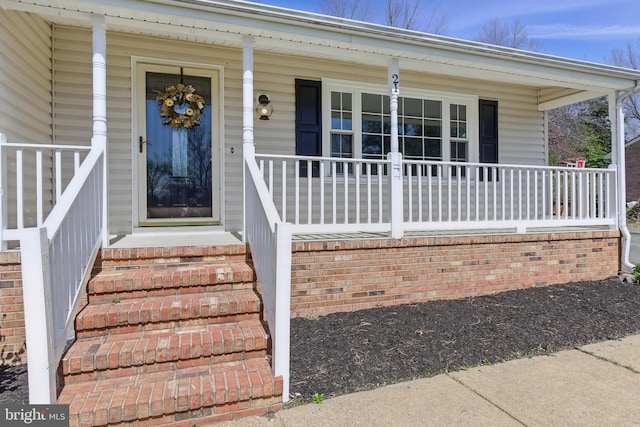 view of exterior entry featuring a porch