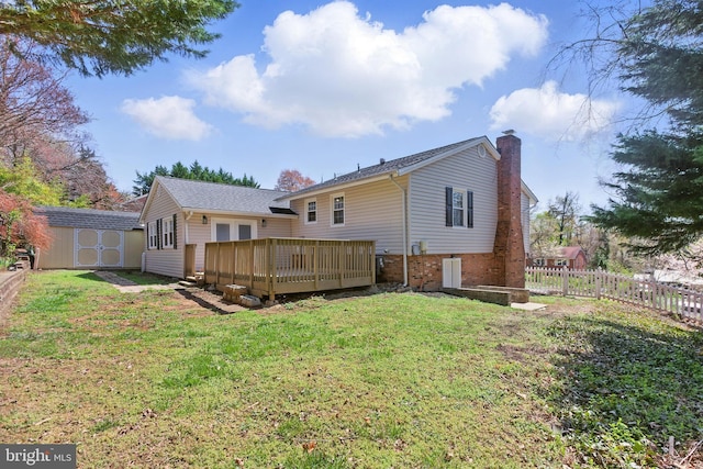 back of property featuring a deck, a chimney, a storage shed, an outbuilding, and brick siding