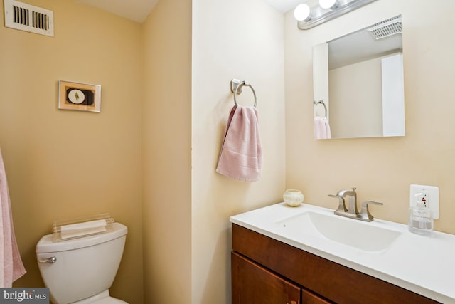 half bathroom featuring toilet and vanity