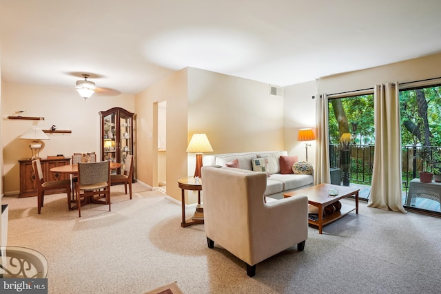 living area with light carpet and baseboards