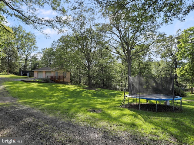 55 Powell Ln, Front Royal, VA 22630 - view of grassy yard with a trampoline, a wooden deck, and a garage