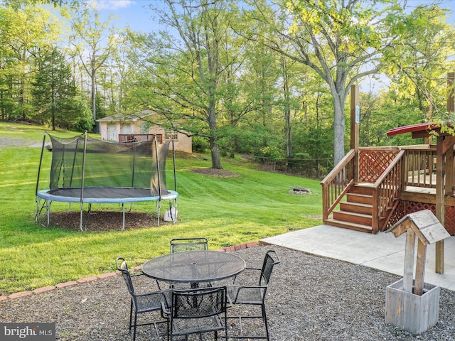 55 Powell Ln, Front Royal, VA 22630 - view of green lawn with a patio area, a deck, a trampoline, and outdoor dining area