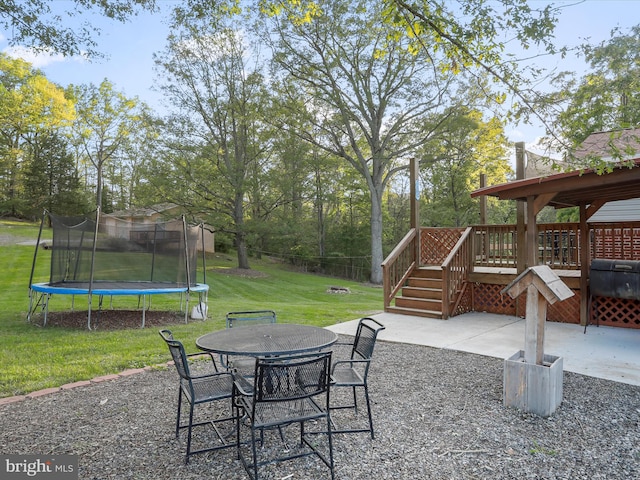 55 Powell Ln, Front Royal, VA 22630 - view of patio featuring a trampoline, a wooden deck, outdoor dining space, and stairway
