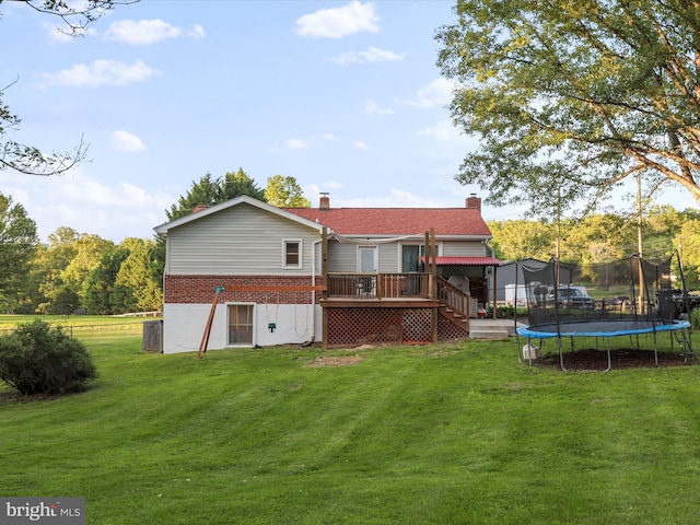 55 Powell Ln, Front Royal, VA 22630 - back of property featuring a trampoline, stairway, brick siding, a wooden deck, and a yard