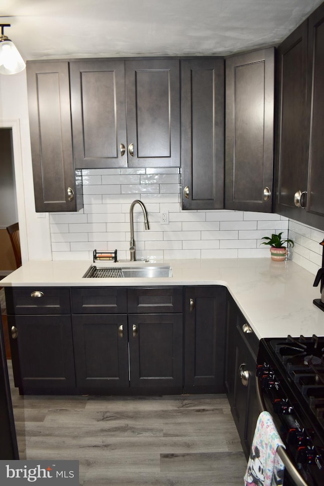 7340 Hasbrook Ave, Philadelphia, PA 19111 - kitchen with a sink, tasteful backsplash, light wood-type flooring, and light countertops