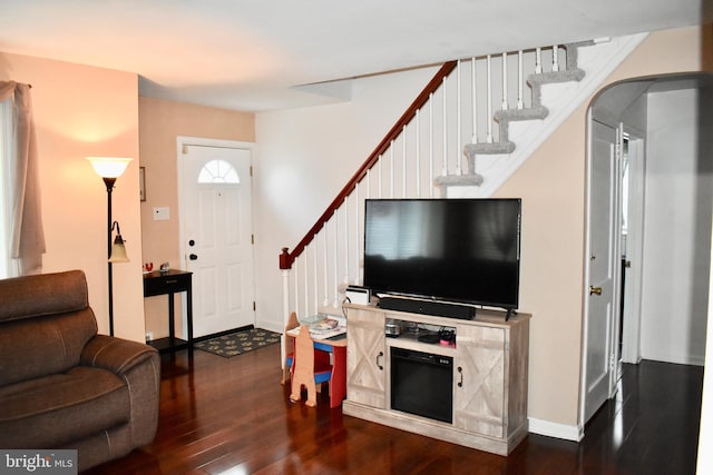 7340 Hasbrook Ave, Philadelphia, PA 19111 - living area with dark wood-style floors, stairway, baseboards, and arched walkways