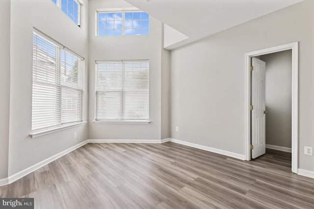 unfurnished room featuring wood finished floors and baseboards