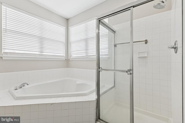 full bath featuring a stall shower and a bath