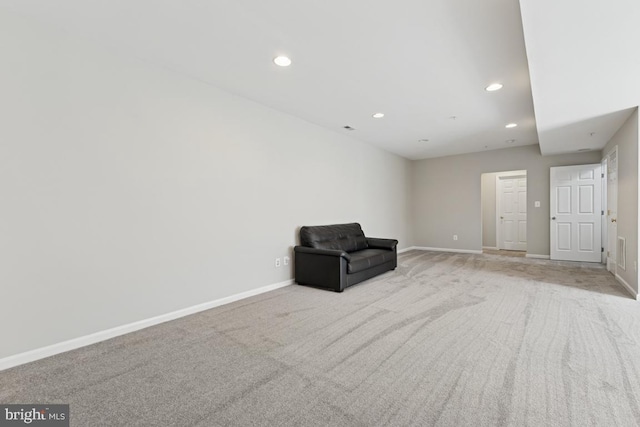 unfurnished room with light carpet, recessed lighting, and baseboards