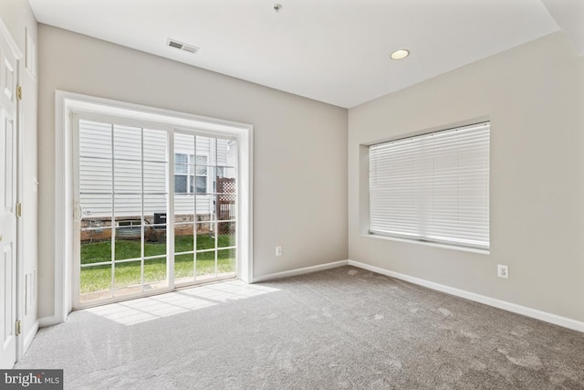 empty room with carpet floors, baseboards, and recessed lighting