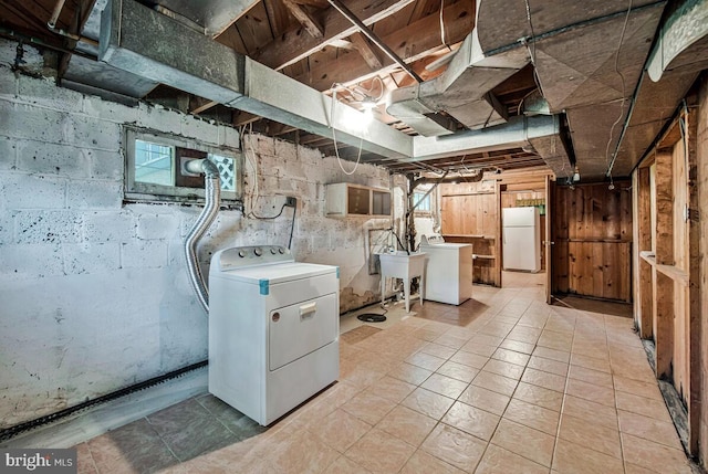 9425 Washington Blvd, Lanham, MD 20706 - laundry area with washing machine and dryer and light tile patterned floors