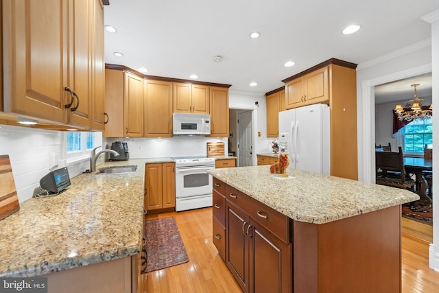 205 Hitching Post Dr, Wilmington, DE 19803 - kitchen featuring white appliances, a sink, ornamental molding, a center island, and light stone counters