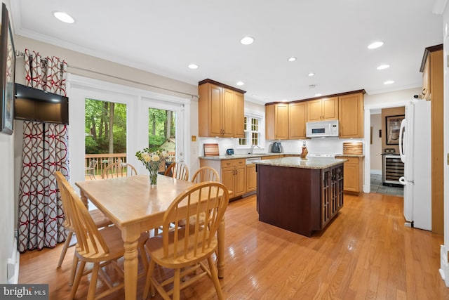 205 Hitching Post Dr, Wilmington, DE 19803 - kitchen with white appliances, light wood-style floors, a center island, ornamental molding, and recessed lighting