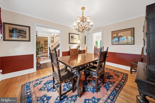 205 Hitching Post Dr, Wilmington, DE 19803 - dining room featuring a chandelier, crown molding, light wood-type flooring, baseboards, and stairway