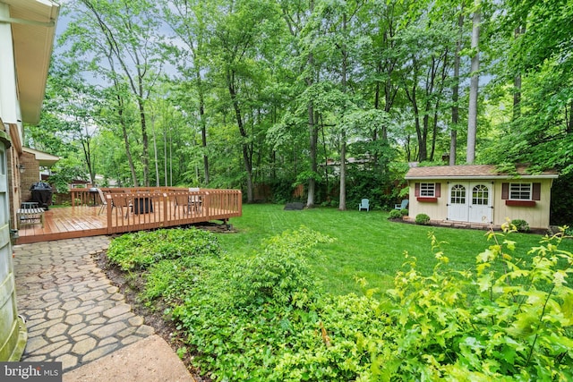 205 Hitching Post Dr, Wilmington, DE 19803 - view of green lawn featuring a deck, an outdoor structure, and view of wooded area