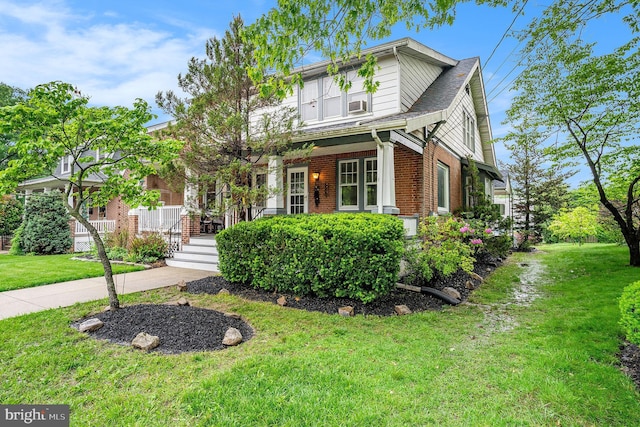 119 S Main St, Telford, PA 18969 - view of front facade with a front yard, brick siding, and covered porch