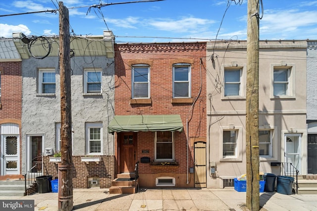 3182 Miller St, Philadelphia, PA 19134 - view of property featuring brick siding, entry steps, and stucco siding