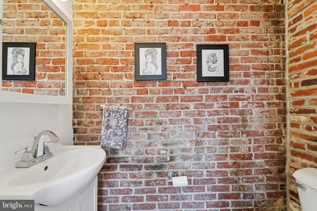 3182 Miller St, Philadelphia, PA 19134 - bathroom with brick wall, vanity, and toilet