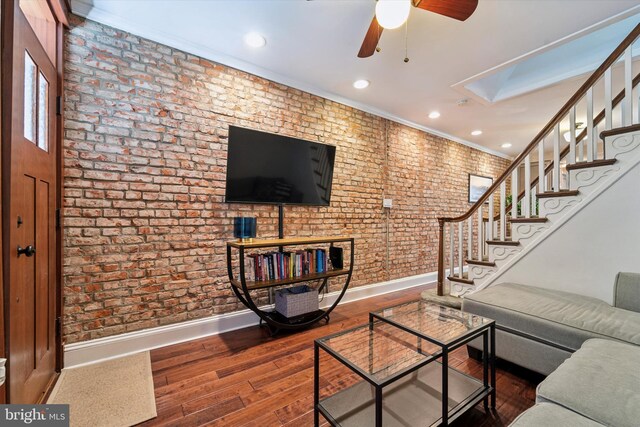 3182 Miller St, Philadelphia, PA 19134 - living area with baseboards, ceiling fan, stairs, a skylight, and brick wall