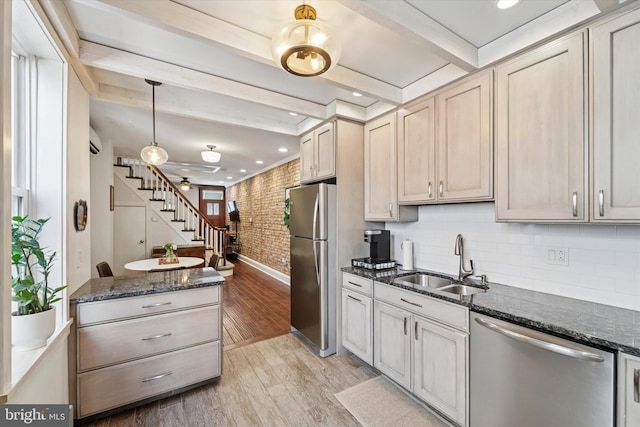 3182 Miller St, Philadelphia, PA 19134 - kitchen with stainless steel appliances, a sink, brick wall, light wood-type flooring, and beam ceiling