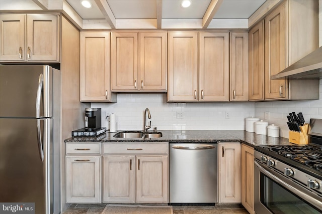 3182 Miller St, Philadelphia, PA 19134 - kitchen with appliances with stainless steel finishes, wall chimney exhaust hood, a sink, dark stone counters, and light brown cabinets