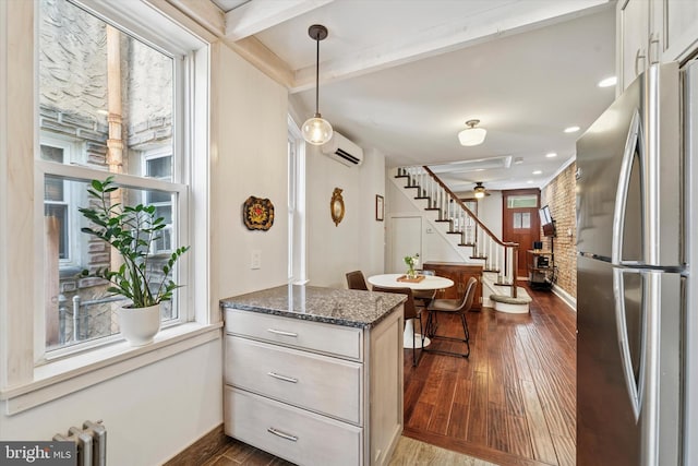3182 Miller St, Philadelphia, PA 19134 - kitchen with freestanding refrigerator, plenty of natural light, baseboards, a peninsula, and beamed ceiling