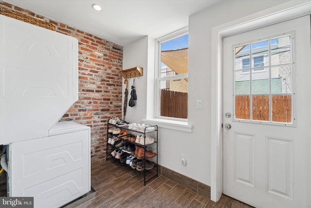 3182 Miller St, Philadelphia, PA 19134 - entryway with stacked washer / drying machine, wood finished floors, baseboards, healthy amount of natural light, and recessed lighting