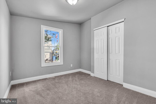 19 E Main St, Salem, NJ 08079 - unfurnished bedroom featuring carpet flooring, a closet, and baseboards